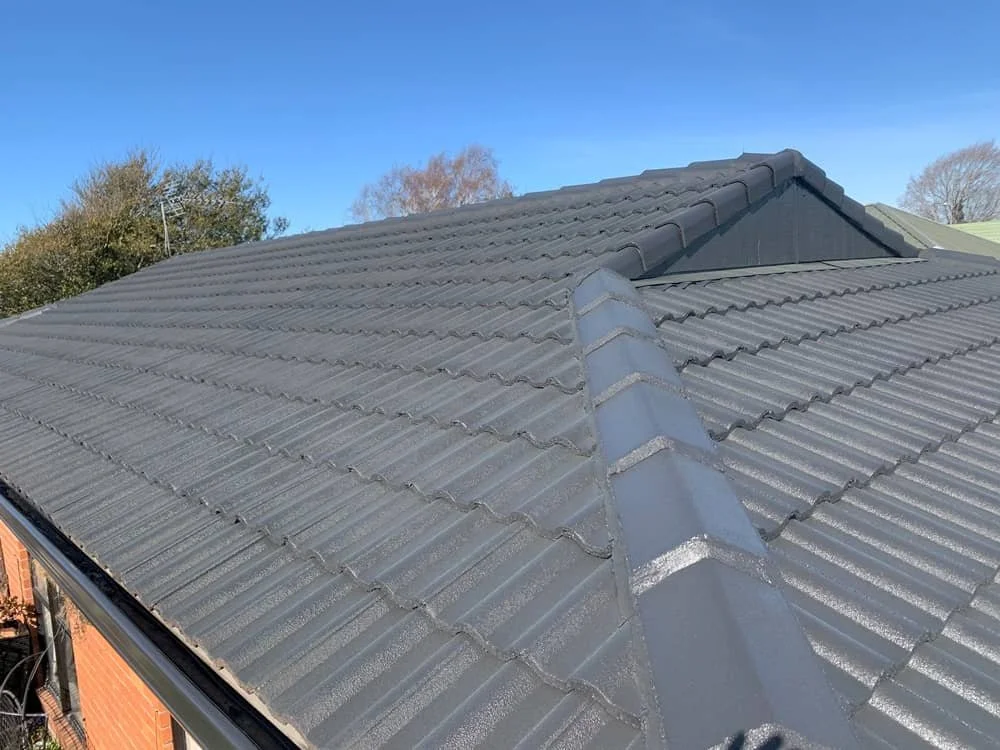 Weathered tile roof before painting in Christchurch, after painting