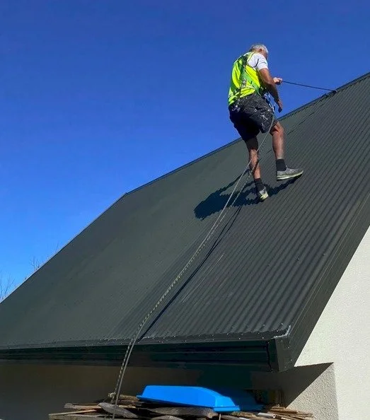Mason Wairau rope and harness roof specialist at work in Christchurch